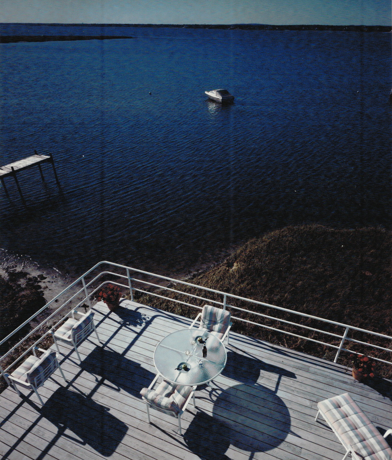 View of first floor deck and water view from upper deck.