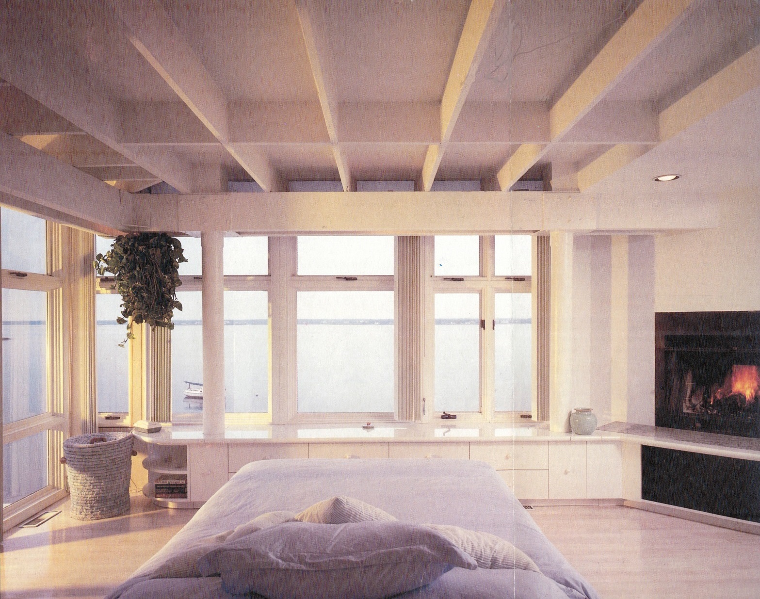 Architectural residential design of added master bedroom fireplace, cabinetry and water view.